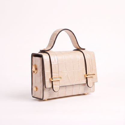 A structured top-handle handbag in textured beige faux crocodile leather with gold-tone hardware and dark brown trim, shown on a clean white background.