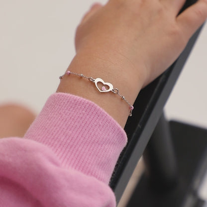 Age Group: Adorable for Toddlers, Young Girls &amp; Preteens; Safe for Sensitive Skin
Material: 925 Sterling Silver
Bracelet Size: 5 inches with extension up to 6", heart &amp; round beads (pink enamel); Adjustable
Metal Stamp: 925
Video of a young girl wearing sterling silver heart bracelet on her hand 