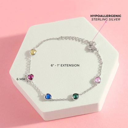 Age Group: Cute for Little Girls and Preteens; Safe for Sensitive Skin
Material: 925 Sterling Silver
Bracelet Length: 6 inches, 1 inch extension
Main Stone: Multi-Colored Cubic Zirconia
Metal Stamp: 925
Overhead picture of the full bracelet showing dimensions and listing materials