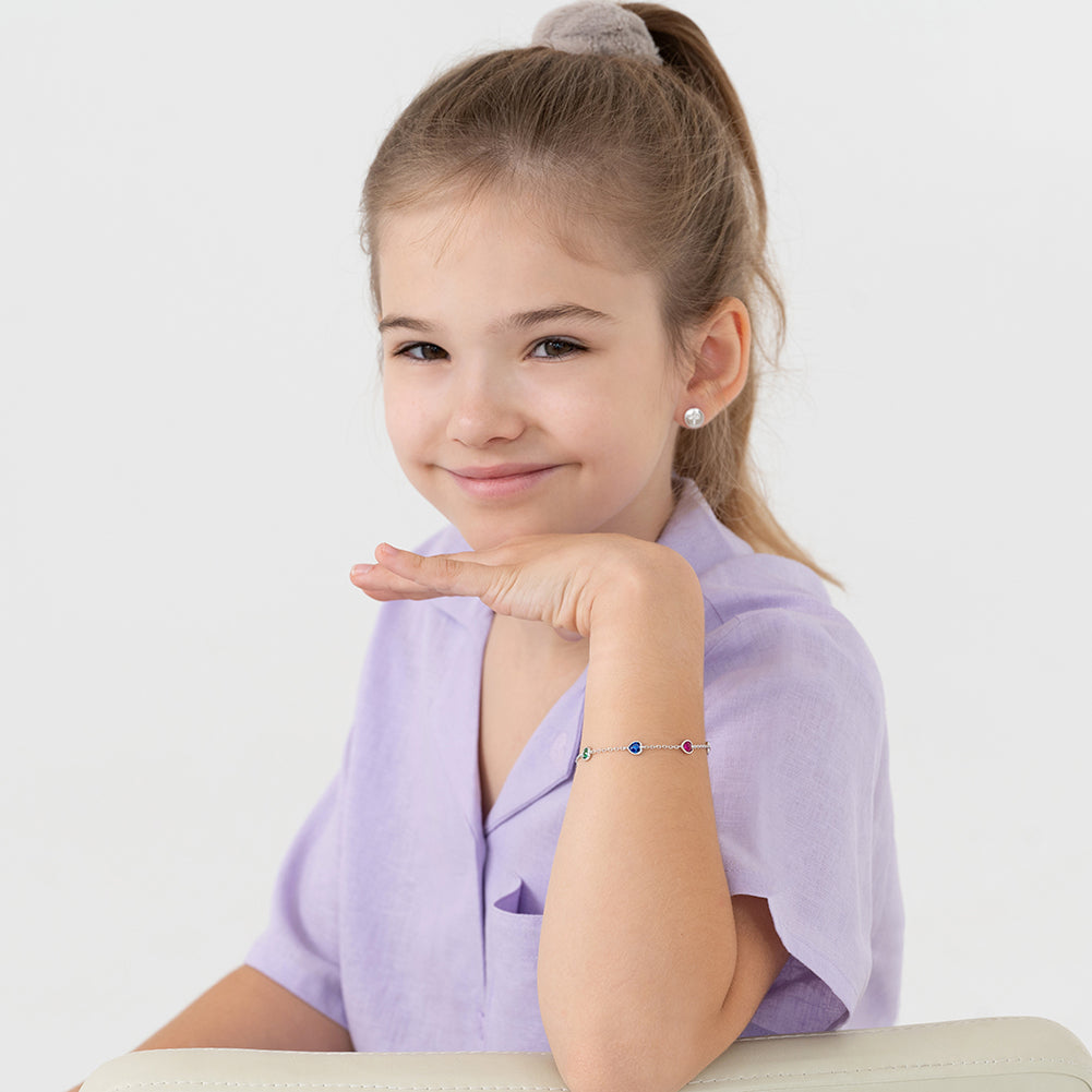 Age Group: Cute for Little Girls and Preteens; Safe for Sensitive Skin
Material: 925 Sterling Silver
Bracelet Length: 6 inches, 1 inch extension
Main Stone: Multi-Colored Cubic Zirconia
Metal Stamp: 925
Picture of little girl wearing the braelet on her arm