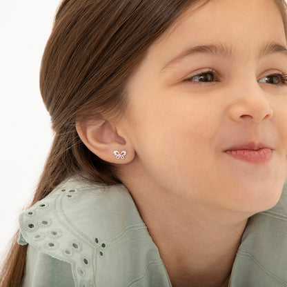Age Group: Ideal for Infants, Toddlers and Girls; Safe for Sensitive Ears
925 Sterling Silver
Earrings Size: 9mm W x 6mm H Bow; 8mm post
Main Stone: Pink and Clear Cubic Zirconia
Metal Stamp: 925
Window Box Included
Butterfly earrings being worn by young girl close up