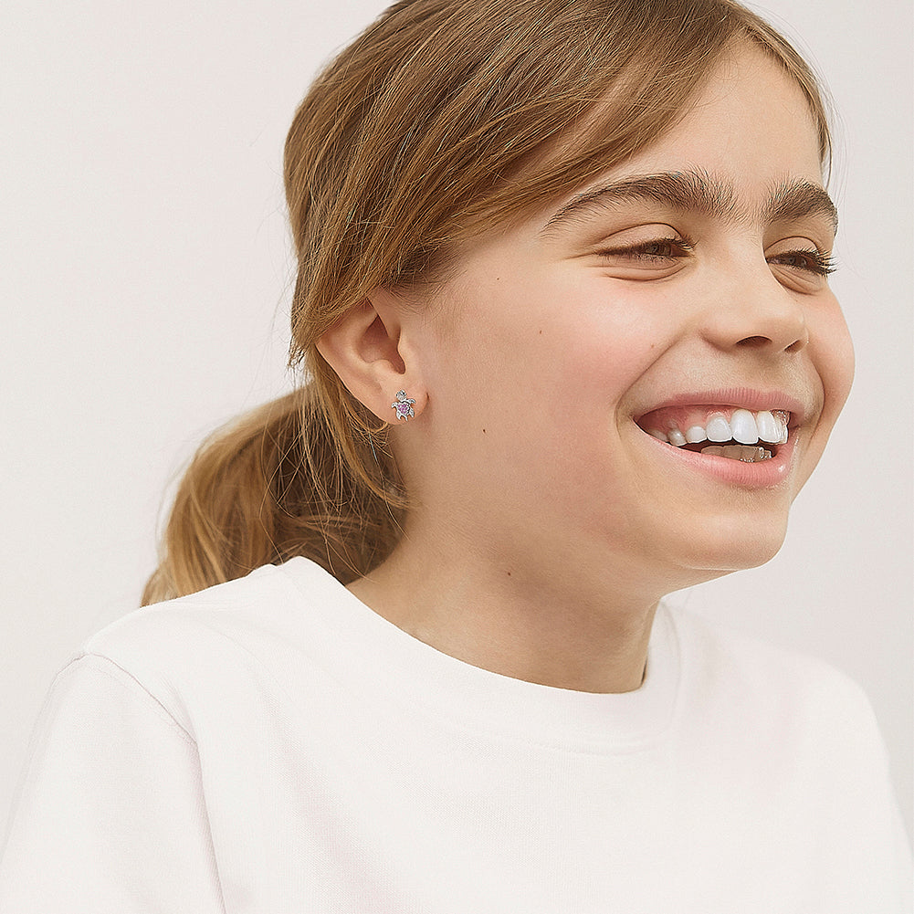 Age Group: Adorable for Little Girls, Young Teens to Teens (ages 5-15 years); Safe for Sensitive Ears
Material: 925 Sterling Silver
Earrings Size: 8mm W x 10mm H turtle, cubic zirconia; 7mm threaded earring post
Metal Stamp: 925
picture of young girl wearing the turtle earrings