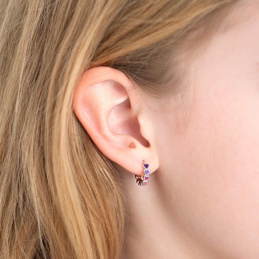 Age Group: Cute for Girls or Teens; Safe for Sensitive Ears
925 Sterling Silver
Earring Size: Outer: 0.47 in. (12mm); Inner: 0.35 in. (9mm)
Metal Stamp: 925
Cascading heart design with purple and pink earrings on sterling silver. Close up picture of the girl's earring
