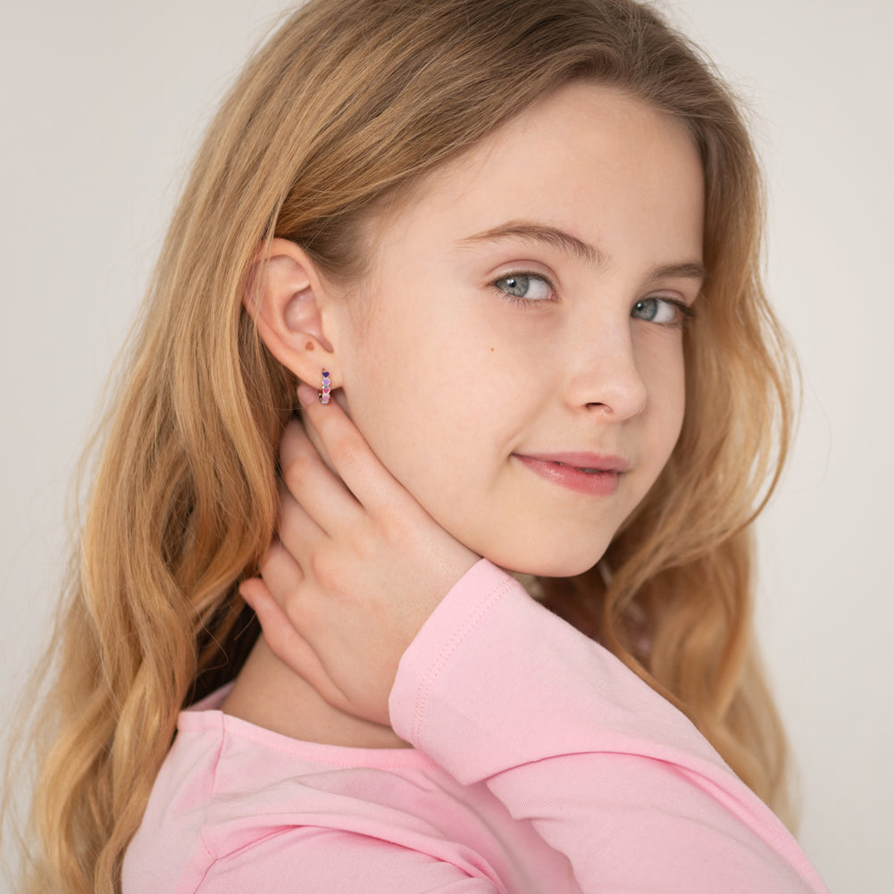 Age Group: Cute for Girls or Teens; Safe for Sensitive Ears
925 Sterling Silver
Earring Size: Outer: 0.47 in. (12mm); Inner: 0.35 in. (9mm)
Metal Stamp: 925
Cascading heart design with purple and pink earrings on sterling silver. Young girl wearing the earrings.