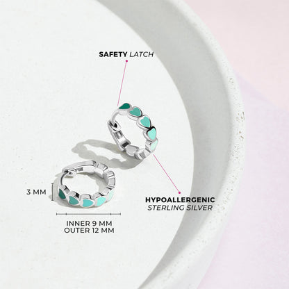 Age Group: Cute for Girls or Teens; Safe for Sensitive Ears
925 Sterling Silver
Earring Size: Outer: 0.47 in. (12mm); Inner: 0.35 in. (9mm)
Metal Stamp: 925
Cascading heart design with multiple green tone earrings on sterling silver. Picture of close up with measurements and materials listed. 