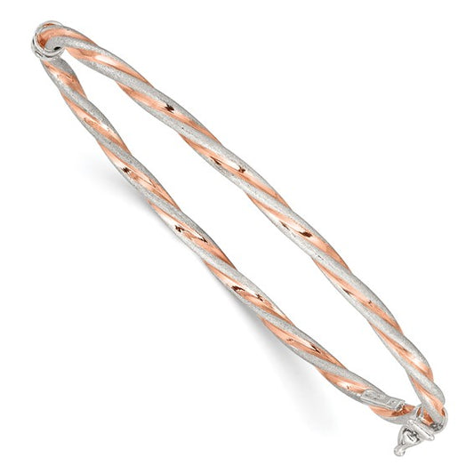 Two-tone silver and rose gold bangle on a white background
Material: .925 sterling Silver Rose-tone Satin
Color: rose gold tone, silver twisted design
Closure: box latch
Measurement: 7" circumference, 3 mm width