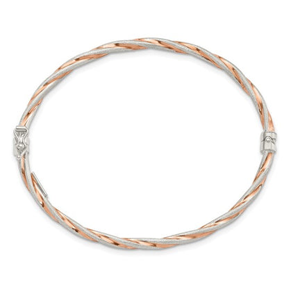 Two-tone silver and rose gold bracelet on a white background
Material: .925 sterling Silver Rose-tone Satin
Color: rose gold tone, silver twisted design
Closure: box latch
Measurement: 7" circumference, 3 mm width